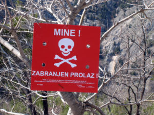 Landmine caution signs in hazardous areas.